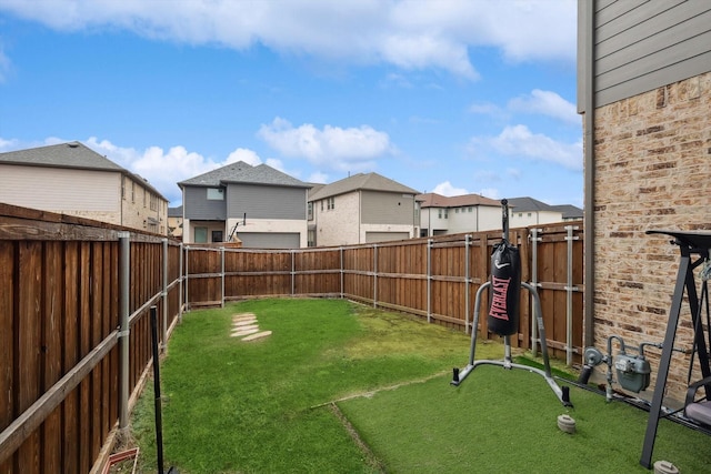 view of yard with a fenced backyard and a residential view