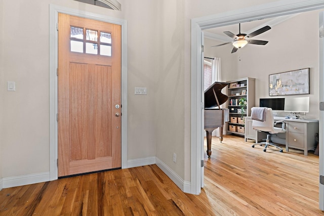 foyer entrance featuring ceiling fan, baseboards, and wood finished floors