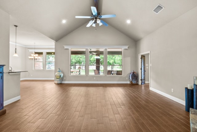 unfurnished living room featuring a wealth of natural light, dark wood-style flooring, and visible vents