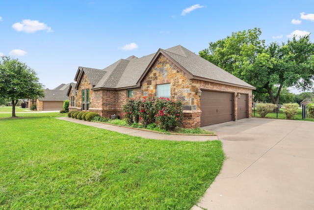 view of front of property with a garage, brick siding, concrete driveway, stone siding, and a front yard