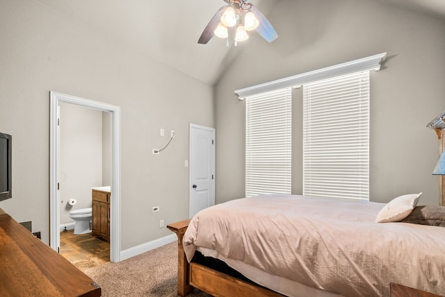 bedroom with light colored carpet, ensuite bathroom, ceiling fan, vaulted ceiling, and baseboards