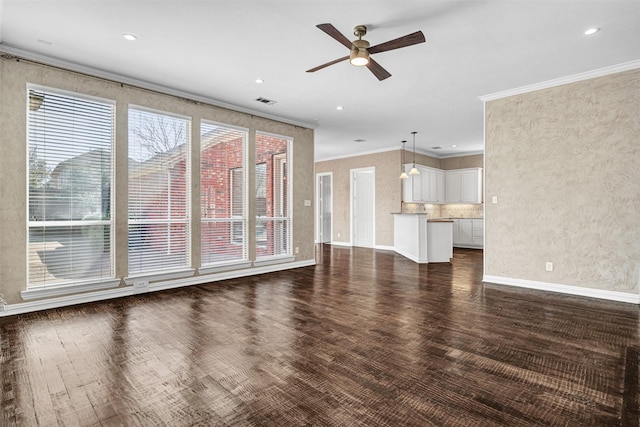 unfurnished living room with baseboards, visible vents, a ceiling fan, dark wood finished floors, and crown molding