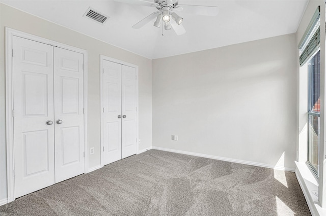 8108 Hazeltine Dr, Plano, TX 75025 - unfurnished bedroom with carpet floors, two closets, baseboards, and a ceiling fan
