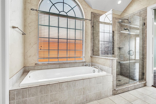 full bath featuring a stall shower, tile patterned flooring, a garden tub, and lofted ceiling