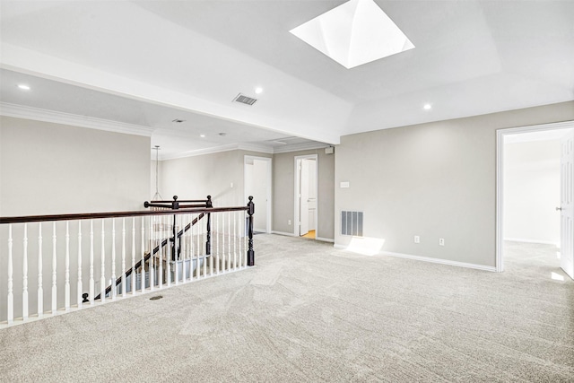 unfurnished room featuring a skylight, visible vents, a raised ceiling, and recessed lighting