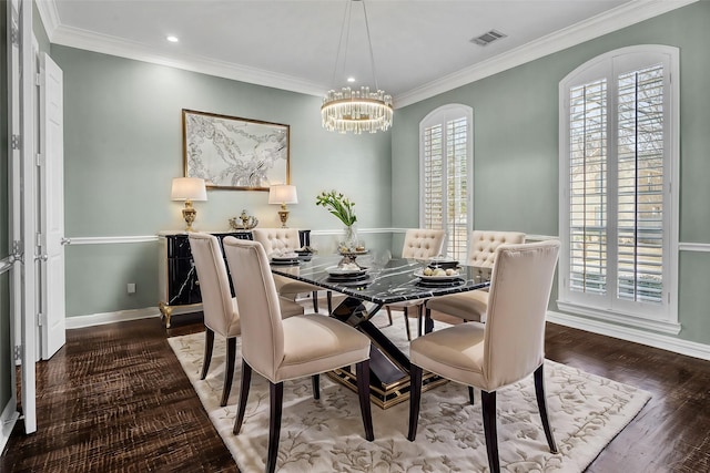 dining space featuring an inviting chandelier, crown molding, baseboards, and hardwood / wood-style flooring