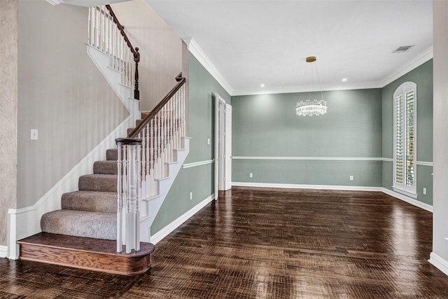 interior space featuring baseboards, crown molding, visible vents, and wood finished floors