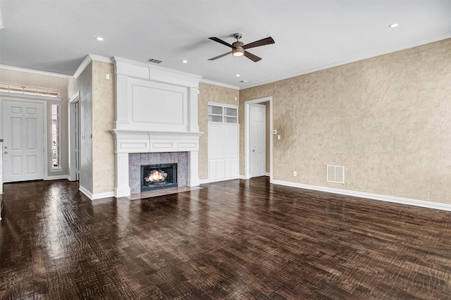 unfurnished living room featuring visible vents, ornamental molding, a tiled fireplace, and wood finished floors