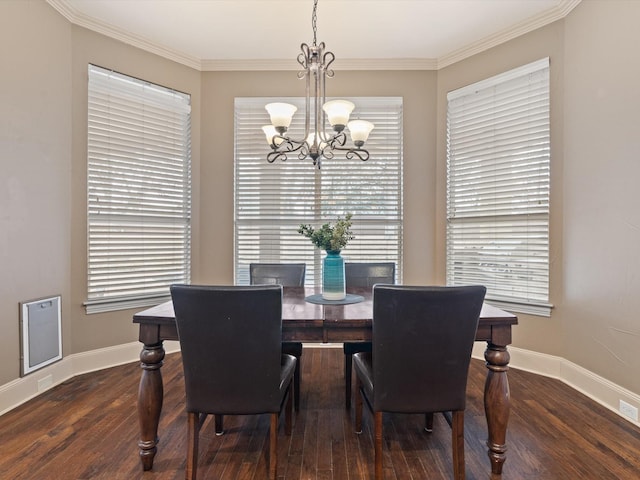 dining space featuring baseboards, crown molding, wood finished floors, and a notable chandelier