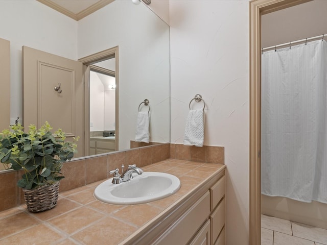 bathroom featuring tile patterned floors, ornamental molding, and vanity