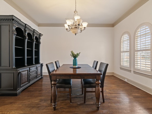 dining area featuring a notable chandelier, crown molding, dark wood finished floors, and baseboards