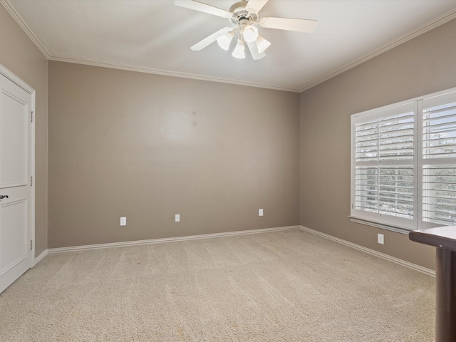 empty room with ceiling fan, ornamental molding, baseboards, and light colored carpet