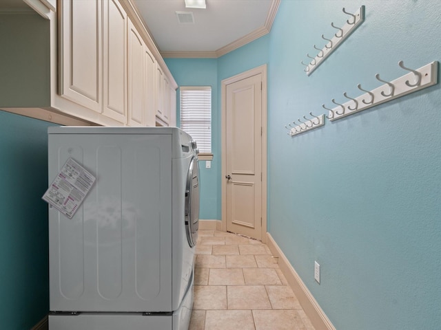 laundry area featuring cabinet space, light tile patterned floors, baseboards, ornamental molding, and washer and dryer