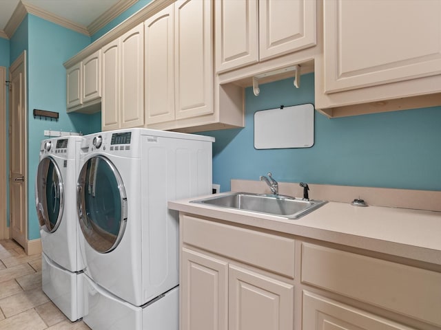 laundry room featuring cabinet space, crown molding, a sink, and independent washer and dryer