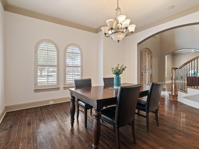 dining area featuring hardwood / wood-style flooring, baseboards, stairs, and arched walkways