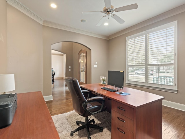 office featuring arched walkways, dark wood finished floors, and crown molding