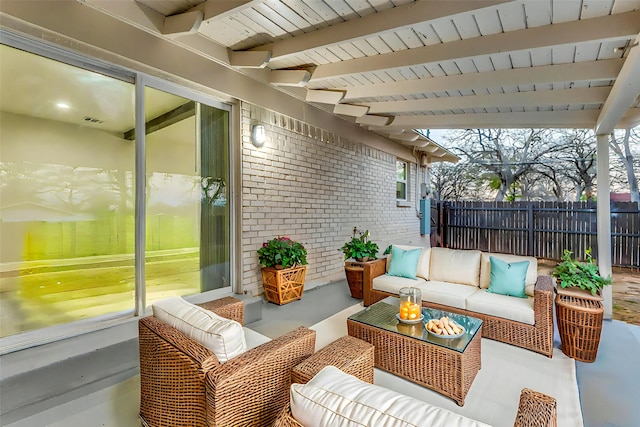 view of patio / terrace with outdoor lounge area, fence, and visible vents