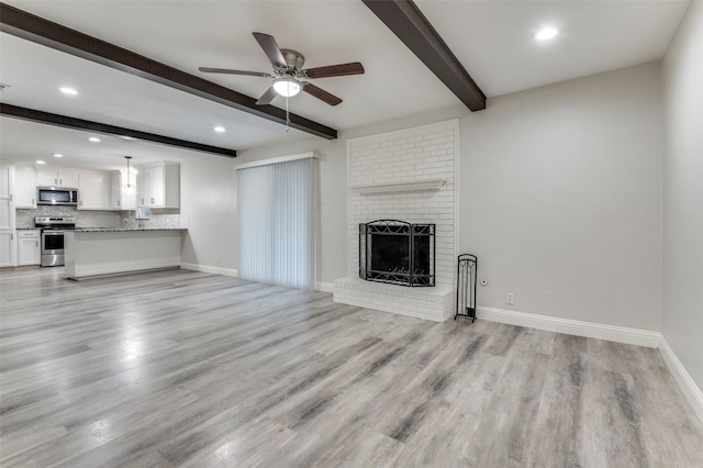 unfurnished living room featuring light wood-type flooring, a fireplace, and baseboards