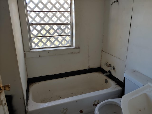 bathroom with a bathing tub and toilet