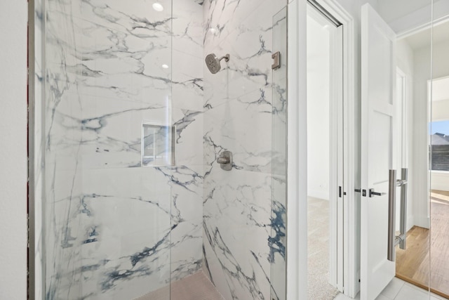 bathroom with a marble finish shower