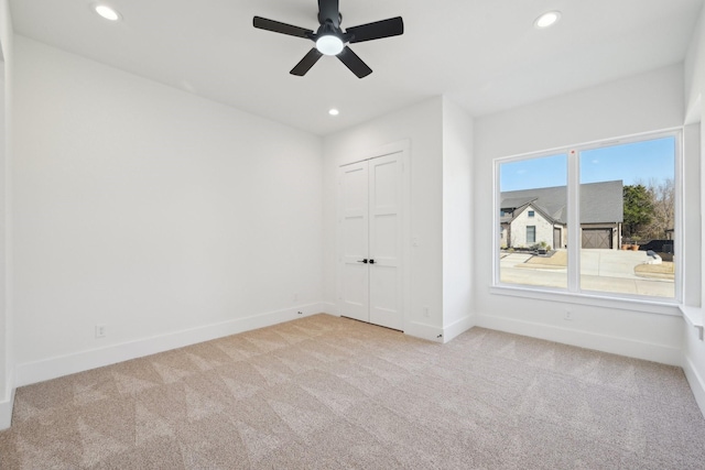 carpeted empty room featuring a ceiling fan, recessed lighting, and baseboards