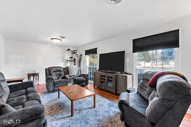 living room featuring visible vents and wood finished floors