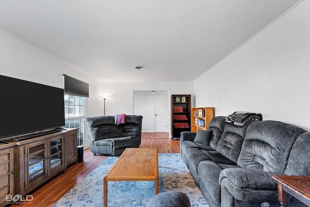 living area featuring visible vents, crown molding, and wood finished floors