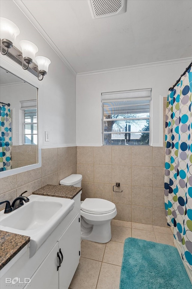 full bath featuring tile walls, vanity, visible vents, and tile patterned floors