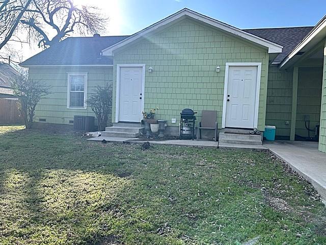 exterior space with entry steps, crawl space, and a lawn