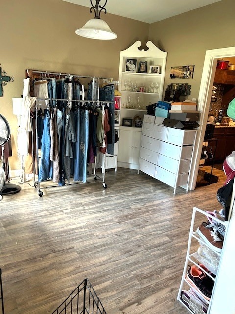 spacious closet featuring lofted ceiling and wood finished floors