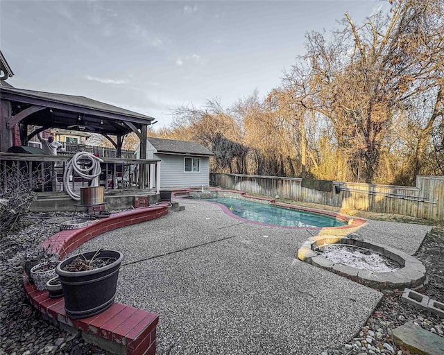 view of pool featuring a deck, a patio area, a fenced backyard, and a fenced in pool