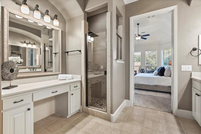 ensuite bathroom featuring ensuite bathroom, a stall shower, vanity, and tile patterned floors