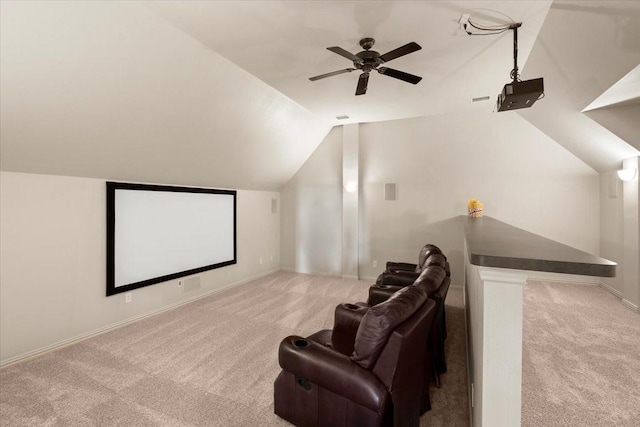 home theater with vaulted ceiling, ceiling fan, carpet flooring, and baseboards