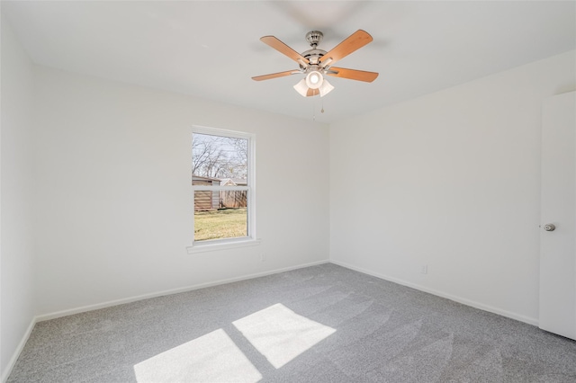 unfurnished room featuring carpet floors, baseboards, and a ceiling fan