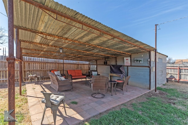 view of patio with an outdoor hangout area and fence