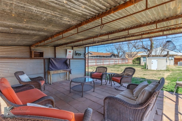 view of patio / terrace featuring an outbuilding, outdoor lounge area, and a storage shed