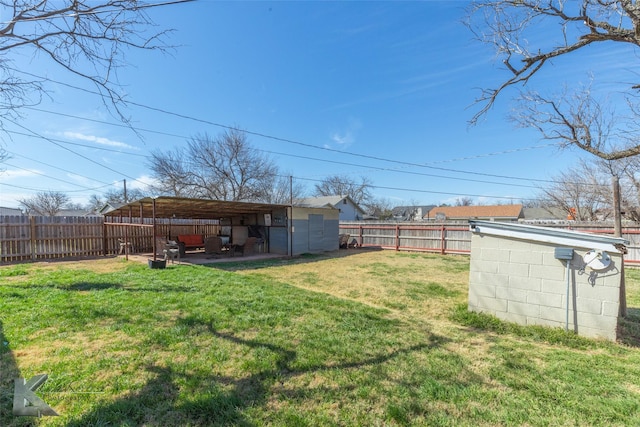 view of yard with a fenced backyard and an outbuilding