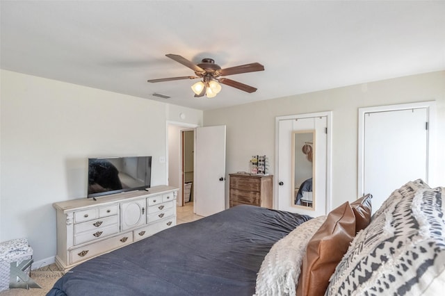 bedroom with ceiling fan, visible vents, and baseboards