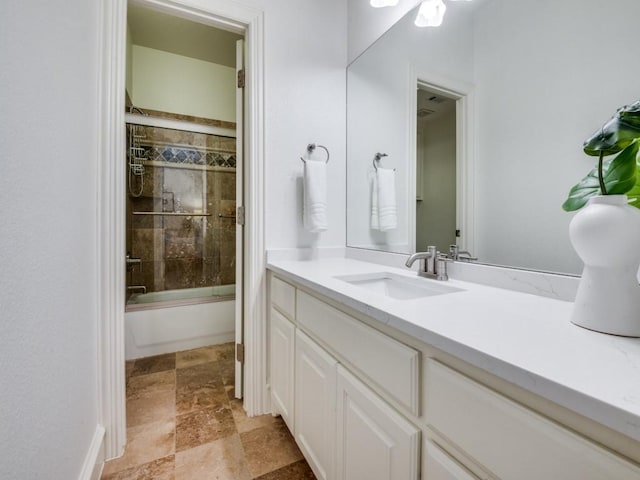 4520 Gilbert Ave, Dallas, TX 75219 - bathroom featuring vanity, stone finish flooring, and enclosed tub / shower combo