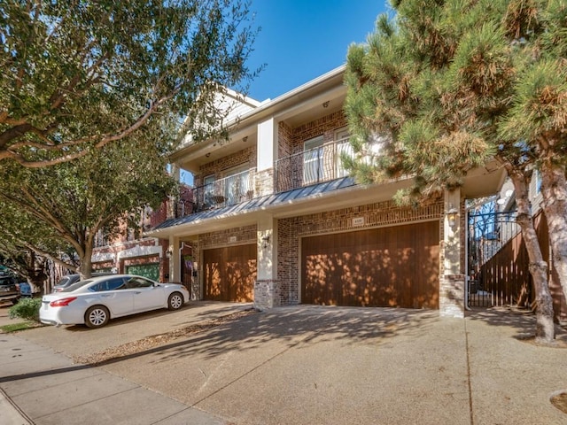 4520 Gilbert Ave, Dallas, TX 75219 - multi unit property with driveway, brick siding, a garage, a balcony, and a standing seam roof
