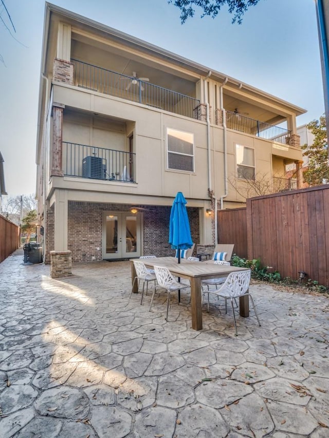 4520 Gilbert Ave, Dallas, TX 75219 - rear view of house with a patio, french doors, brick siding, and outdoor dining space