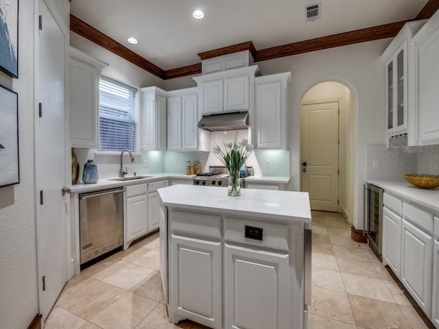 4520 Gilbert Ave, Dallas, TX 75219 - kitchen featuring stainless steel dishwasher, ornamental molding, beverage cooler, range hood, and white cabinetry