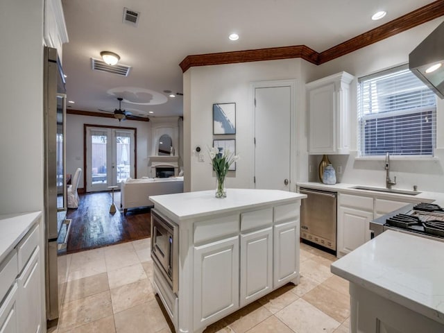 4520 Gilbert Ave, Dallas, TX 75219 - bedroom featuring a tray ceiling, crown molding, light colored carpet, recessed lighting, and ensuite bath