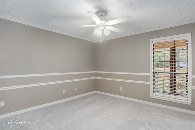 empty room with a textured ceiling, ornamental molding, carpet, and a ceiling fan