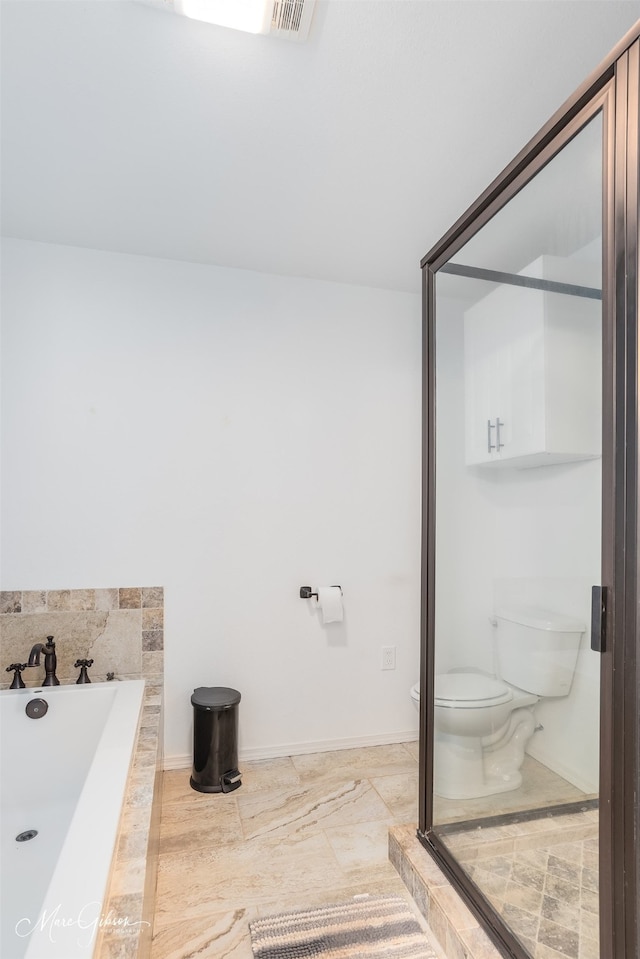 bathroom with visible vents, a bathing tub, and toilet