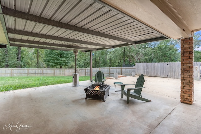 view of patio with a fenced backyard and a fire pit