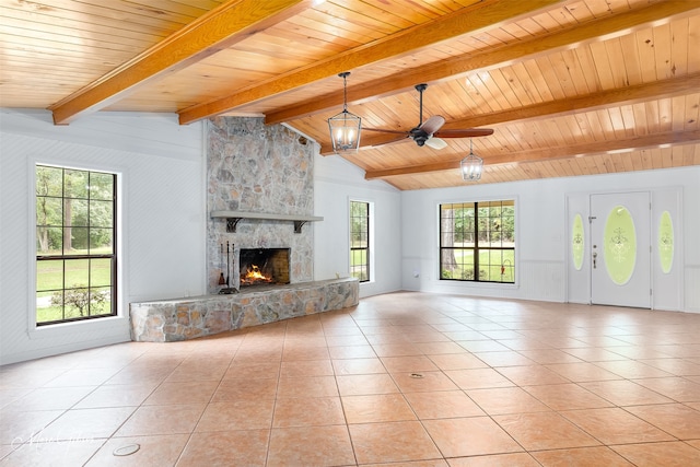 unfurnished living room with a fireplace, lofted ceiling with beams, a ceiling fan, wood ceiling, and light tile patterned flooring