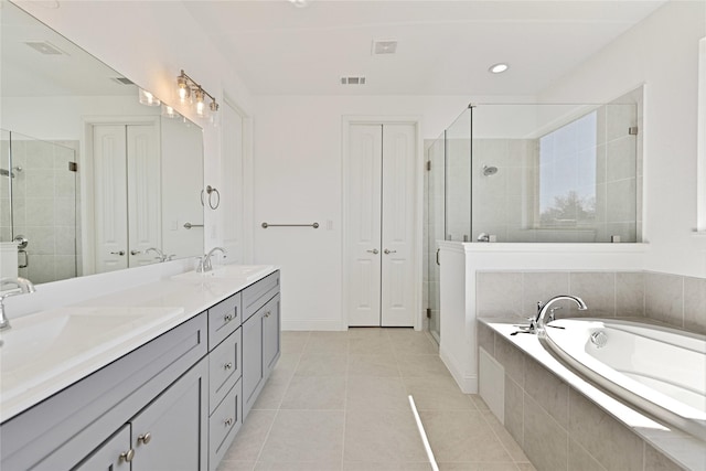 full bath with double vanity, a stall shower, a sink, and a bath