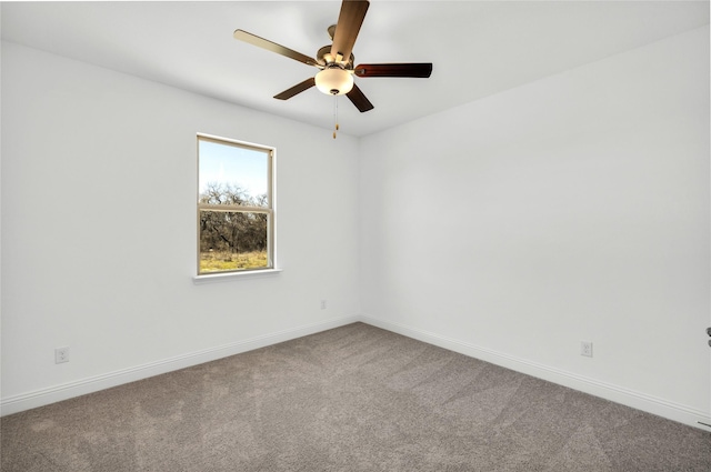 empty room featuring a ceiling fan, baseboards, and carpet flooring