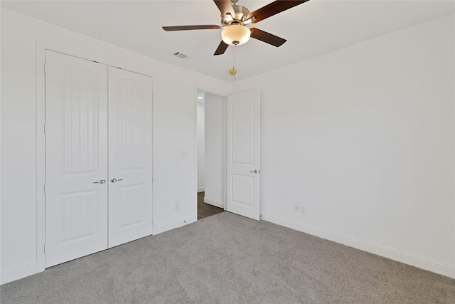 unfurnished bedroom featuring baseboards, carpet, visible vents, and a closet